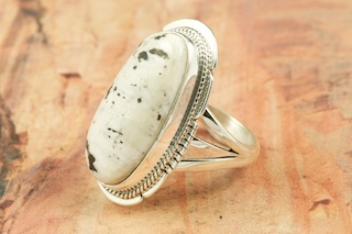 White Buffalo Turquoise set in Sterling Silver Ring. This Beautiful Stone is formed from the minerals Calcite and Iron. It is mined near Tonopah Nevada. Created by Navajo Artist Milton Lee. Signed. 
